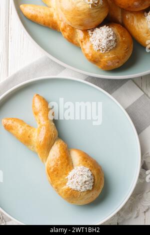Funny bunny buns rolls closeup on the plate on the table. holiday idea. Vertical top view from above Stock Photo