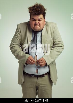 Plus size, man and fitting in shirt for abdomen, professional and annoyed with clothes for work. Adult, male person and guy with stomach, unhappy and Stock Photo