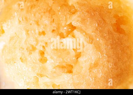 Yellow sugar scrub swatch smear smudge close up. Texture of orange body scrub with salt or sugar. Stock Photo