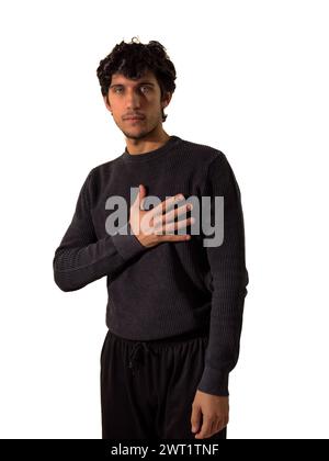 A man is standing with his arms crossed, displaying a confident and assertive posture. He appears strong and composed, with a serious expression on hi Stock Photo