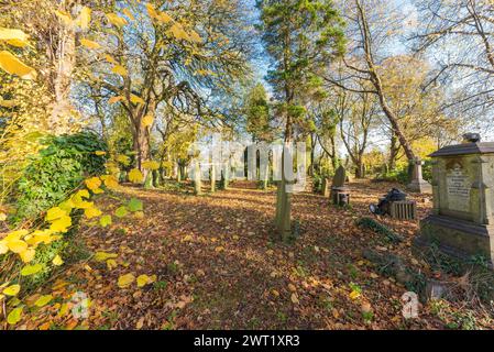 The churchyard at St Peter's Church in Harborne, Birmingham in autumn Stock Photo