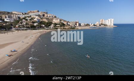 Cullera, Spain - 10 June, 2023: Panoramic view of the Raco beach in Cullera, Valencia, Spain. With people bathing and sunbathing and apartment buildin Stock Photo