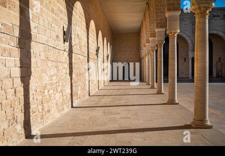 The shadows of traditional Islamic horseshoe arches along the side of the sahn, or courtyard,  in the Great Mosque of Mahdia, Tunisia. Stock Photo