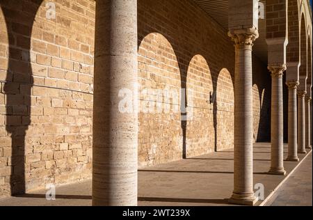 The shadows of traditional Islamic horseshoe arches along the side of the sahn, or courtyard,  in the Great Mosque of Mahdia, Tunisia. Stock Photo