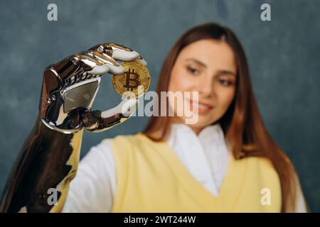 A robotic arm presents a Bitcoin coin, held firmly between its fingers, as a young woman looks on, symbolizing the intersection of technology and cryptocurrency. The Future of Currency in Digital Hands  Stock Photo