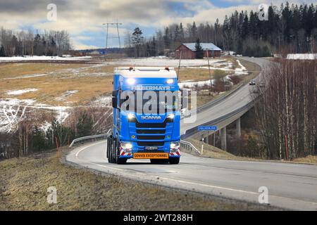 Customized Blue Scania 770S truck Felbermayr for exceptional load transport on road, high beams on briefly. Salo, Finland. March 9, 2024. Stock Photo