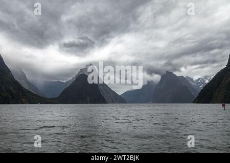 Part of the spectacular Milford Sound, one of the wettest places on the planet, is seen under typically heavy skies over Fiordland, New Zealand. Stock Photo