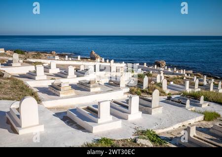 Muslim graves next to the Mediterranean Sea at the ancient Mahdia Maritime Cemetery, Mahdia, Tunisia. Stock Photo