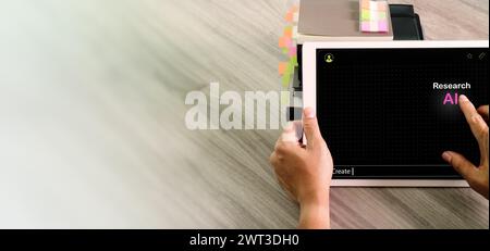Above view of  student using digital tablet computer asks to AI to research write an homework. Someone uses the  AI chat to drafting a document, he as Stock Photo