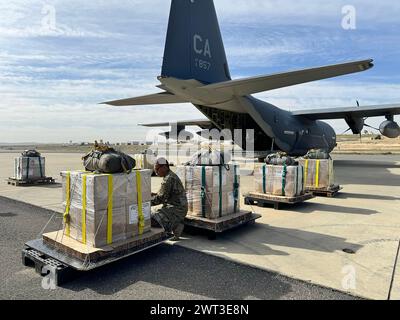U.S. Air Force loadmasters prepare humanitarian aid for airdrop by a U.S. Air Forces Central HC-130J Combat King II Stock Photo