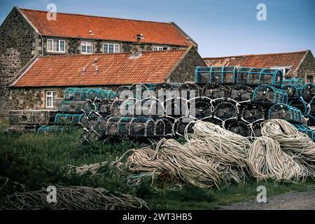 Holy island harbour fishermans house and net lobster pots Stock Photo