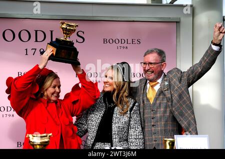 Owner Audrey Turley (left) and husband Greg Turley celebrate with the trophy after Galopin Des Champs ridden by jockey Paul Townend wins the Boodles Cheltenham Gold Cup Chase on day four of the 2024 Cheltenham Festival at Cheltenham Racecourse. Picture date: Friday March 15, 2024. Stock Photo