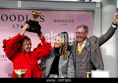 Owner Audrey Turley (left) and husband Greg Turley celebrate with the trophy after Galopin Des Champs ridden by jockey Paul Townend wins the Boodles Cheltenham Gold Cup Chase on day four of the 2024 Cheltenham Festival at Cheltenham Racecourse. Picture date: Friday March 15, 2024. Stock Photo