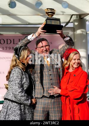 Owner Audrey Turley (right) and husband Greg Turley celebrate with the trophy after Galopin Des Champs ridden by jockey Paul Townend wins the Boodles Cheltenham Gold Cup Chase on day four of the 2024 Cheltenham Festival at Cheltenham Racecourse. Picture date: Friday March 15, 2024. Stock Photo