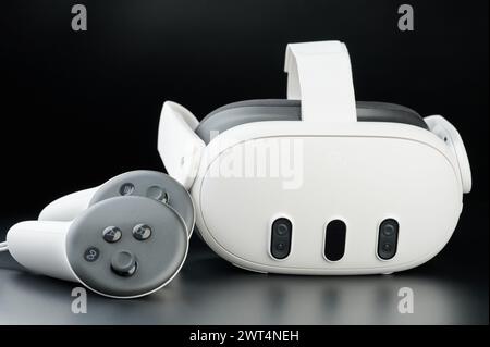 New York, USA - March 15, 2024: Meta oculus quest 3 headset with controllers on black studio background Stock Photo