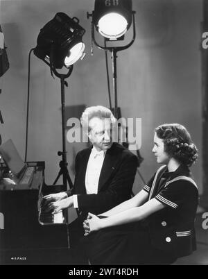 Conductor LEOPOLD STOKOWSKI and DEANNA DURBIN in a publicity photograph for 100 MEN AND A GIRL 1937 Directed by HENRY KOSTER Universal Pictures Stock Photo