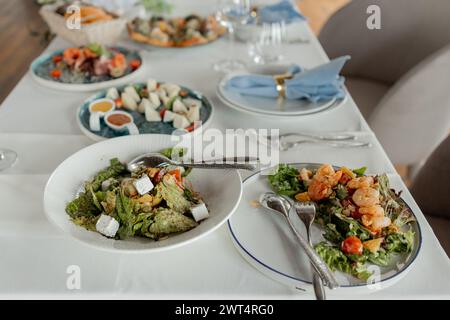 a Elegant dining: fresh salads, seafood, sophisticated setting. Stock Photo
