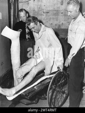American Film Actor JAMES STEWART being fitted with plaster make-up on his leg for his role in REAR WINDOW 1954 Director ALFRED HITCHCOCK Writer JOHN MICHAEL HAYES Costume Design EDITH HEAD Music FRANZ WAXMAN Paramount Pictures Stock Photo