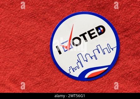 I Voted sticker on a red shirt indicating Republican party. Isolated directly above image, political concept. Stock Photo