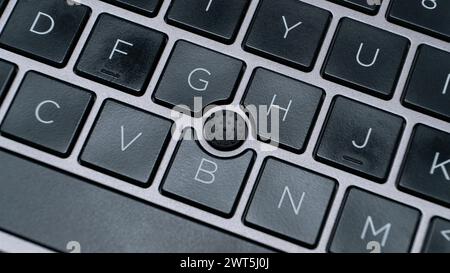 laptop keyboard with focus on pointing stick track point Stock Photo