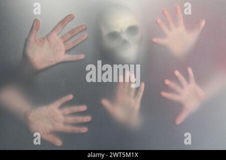 Silhouette of creepy ghost with skull behind cloth Stock Photo