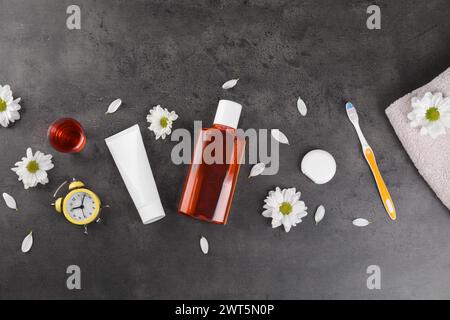 Fresh mouthwash and other oral care products on dark textured table, flat lay Stock Photo
