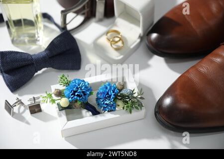Wedding stuff. Composition with stylish boutonniere on white background, closeup Stock Photo