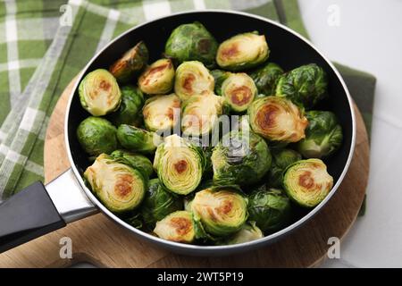 Delicious roasted Brussels sprouts in frying pan on table, closeup Stock Photo