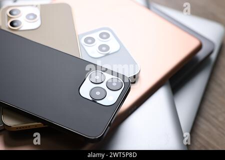 Many different modern gadgets on wooden table Stock Photo