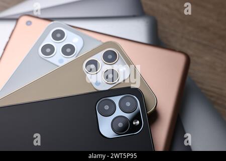 Many different modern gadgets on wooden table Stock Photo