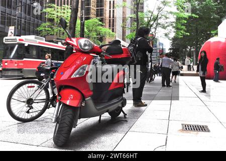 Toronto, Ontario, Canada - 06/12/2009: Red - RedBall art display in Toronto with a red motorcycle and red streetcar Stock Photo