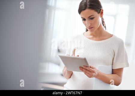 Woman, paper or tablet to search, business or email as digital, review or schedule in office. Businesswoman, touch screen or tech to answer questions Stock Photo