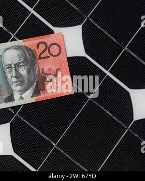 Solar Panels and Australian twenty dollar note demostrating the link between solar generation and electricity bills. Stock Photo