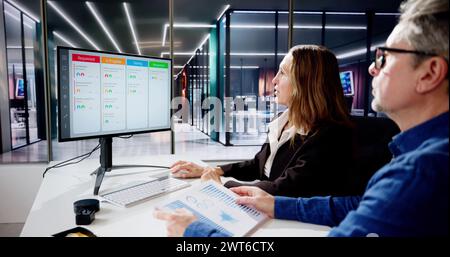 Scrum Project Manager Using Scrum Board Scheduling Software Stock Photo