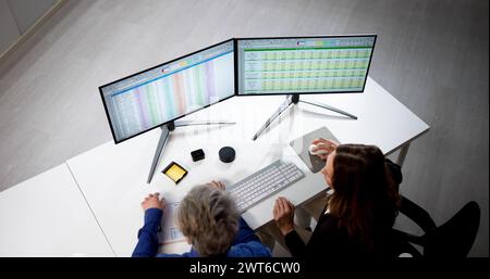 Auditor Employees And Data Analyst Using Computer Spreadsheet Stock Photo