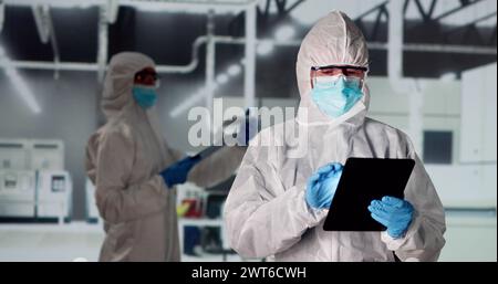 Factory Clean Room Laboratory. Industrial Engineer Using Technology Stock Photo