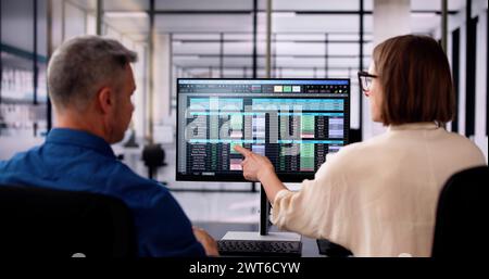 Analyst Employee Working On Spreadsheet Using Desktop Computer Stock Photo