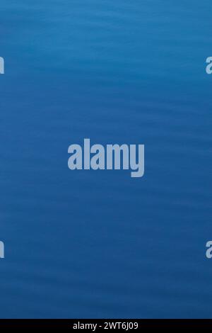 Relaxing background of small waves and ripples of vibrant blue water Stock Photo