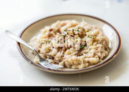 Traditional Slovak dish Halusky - Strapacky with sauerkraut on a plate. Stock Photo