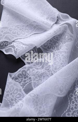 White lace on black background, top view Stock Photo