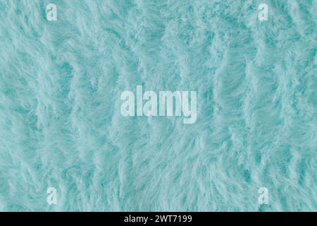 Light blue faux fur background. Close up surface wool texture. Minimal background concept. Trendy color luxury layout. Fluffy fur flat lay. Stock Photo