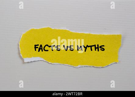 Facts vs myths words written on yellow torn paper piece with white background. Conceptual symbol. Copy space. Stock Photo