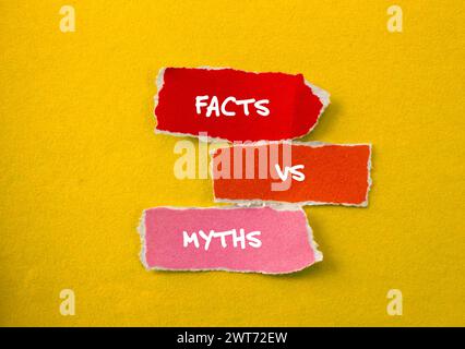 Facts vs myths words written on torn paper pieces with yellow background. Conceptual symbol. Copy space. Stock Photo