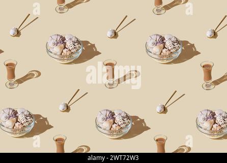 Summer pattern composition made with glass bowl full of sea shells, cream liqueur drink and golden spoon on bright beige background. Minimal concept. Stock Photo