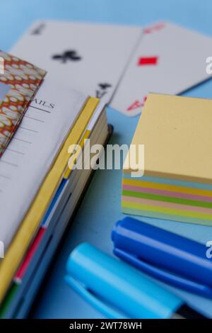 The photo is a photo of stationery in the form of books, pens, and sticky notes taken from a close distance Stock Photo