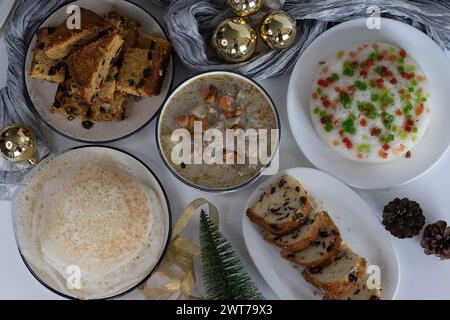 Christmas day breakfast spread prepared in kerala style on the table along with Christmas decorations. Appam, chicken stew, vattayappam, Cranberry ora Stock Photo