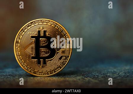 Close up of bitcoin cryptocurrency golden coin against abstract background. Virtual money concept Stock Photo