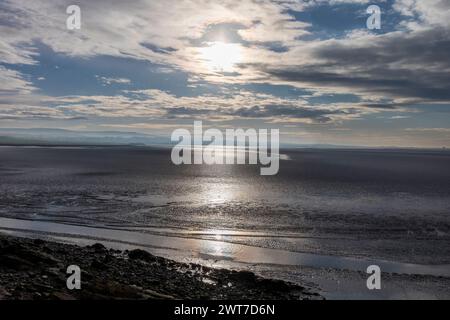 View across sand and mudflats of Morecambe Bay at low tide.  From Jenny, Brown's Point towards Bolton-le-sands. Lancashire, England. December. Stock Photo