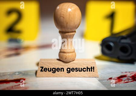 16 March 2024: Stamp made of wood with the inscription: Witnesses wanted at a crime scene with blood and firearm. Symbolic image of the police appeal for witnesses. PHOTOMONTAGE *** Stempel aus Holz mit Aufschrift: Zeugen gesucht an einem Tatort mit Blut und Schusswaffe. Symbolbild Zeugenaufruf der Polizei. FOTOMONTAGE Stock Photo