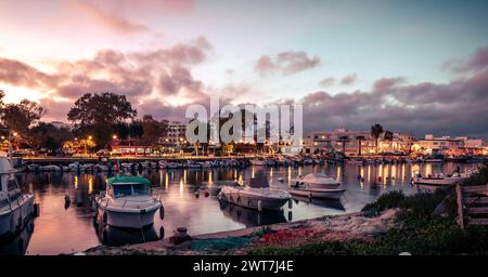 View of the fishing port and the town of Fuseta at dusk Stock Photo